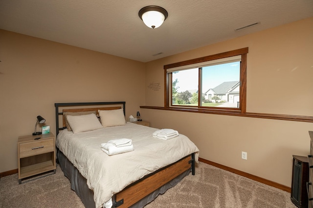 carpeted bedroom with a textured ceiling