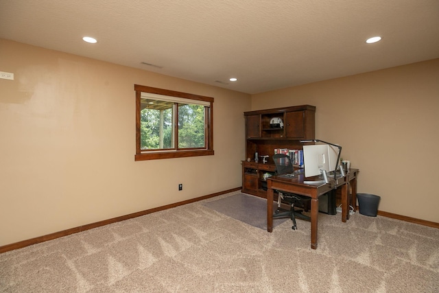 carpeted office with a textured ceiling