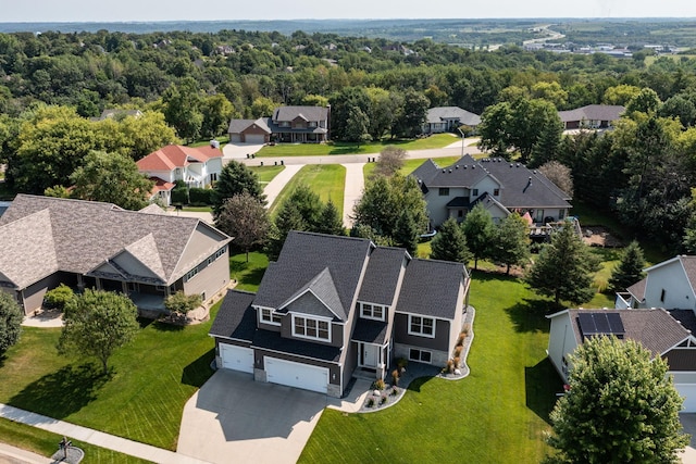 bird's eye view featuring a residential view and a wooded view