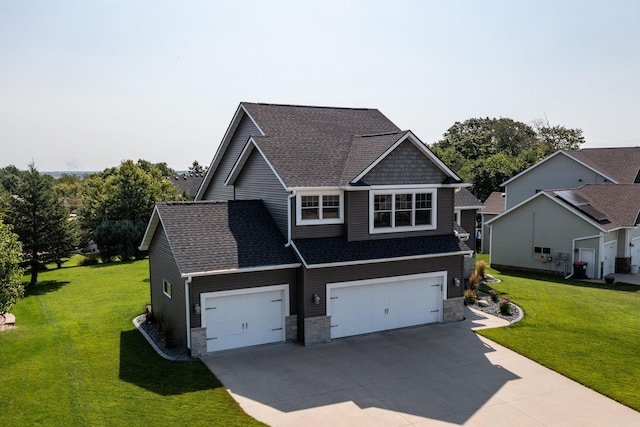 view of front of property featuring a front yard and a garage