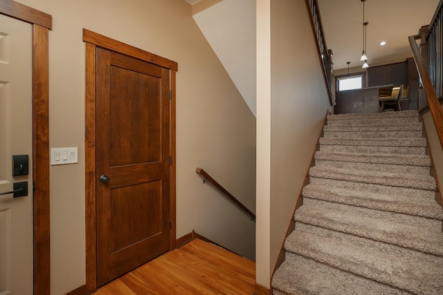 stairway with hardwood / wood-style floors