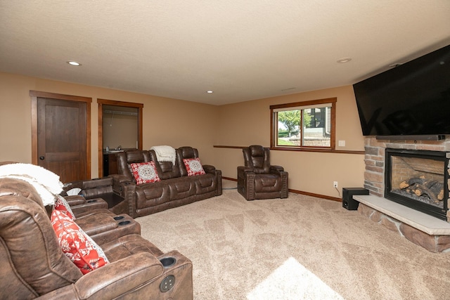 carpeted living room with a textured ceiling and a fireplace