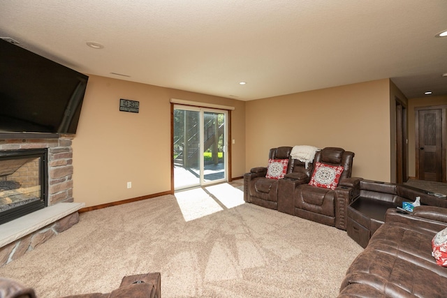 carpeted living room featuring a stone fireplace and a textured ceiling