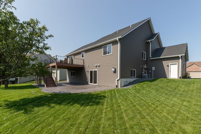 rear view of house with a lawn, a patio, and a deck