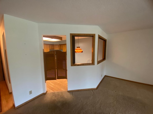 carpeted spare room featuring a textured ceiling