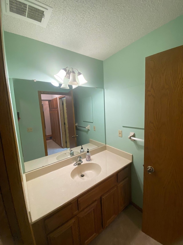 bathroom with vanity and a textured ceiling