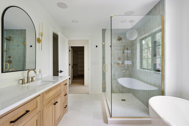 bathroom with independent shower and bath, vanity, and tile patterned flooring