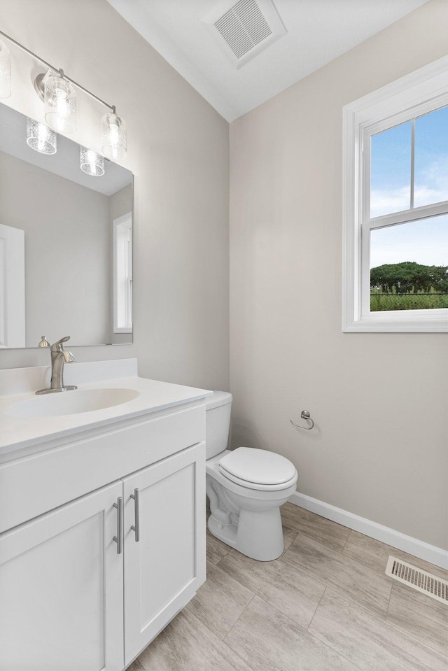 bathroom with vanity, toilet, and tile patterned floors