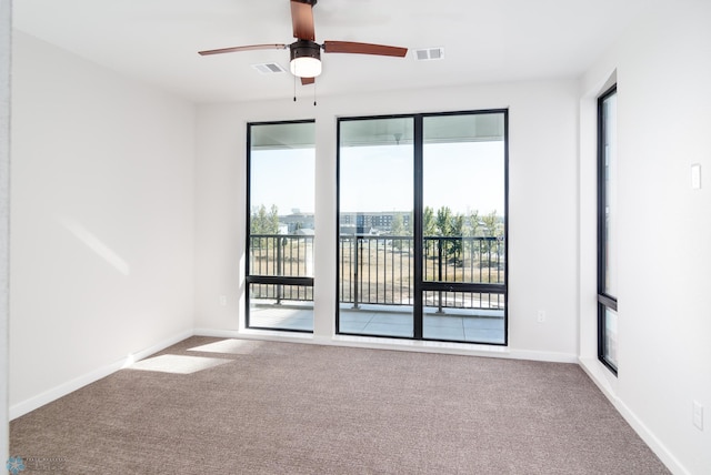 carpeted spare room with ceiling fan