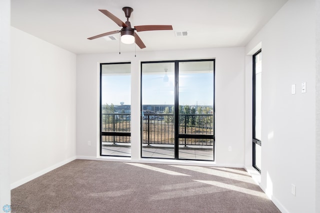 spare room with ceiling fan and light carpet