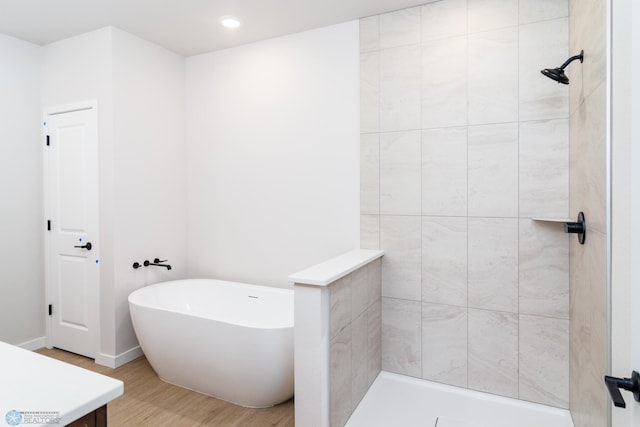 bathroom with shower with separate bathtub, vanity, and hardwood / wood-style floors