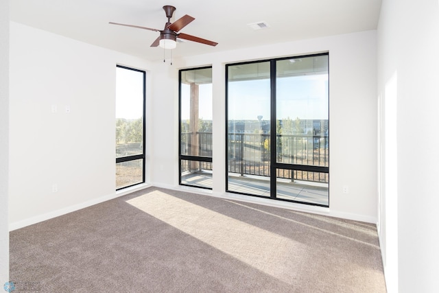 empty room featuring ceiling fan and carpet flooring