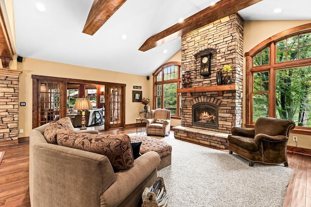living area with a fireplace, high vaulted ceiling, beamed ceiling, and wood-type flooring