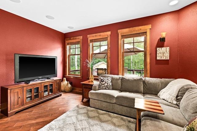 living room with baseboards, a textured wall, and wood finished floors