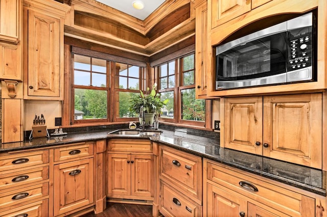 5325 Roosevelt Dr, Hermantown, MN 55811 - kitchen with stainless steel microwave, a sink, dark stone counters, and dark wood-style floors