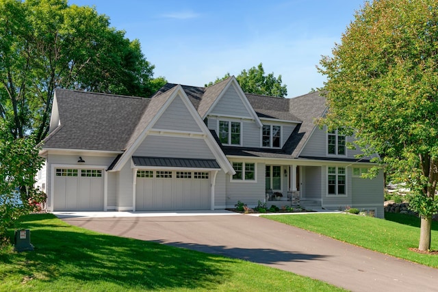 craftsman house featuring a garage and a front yard