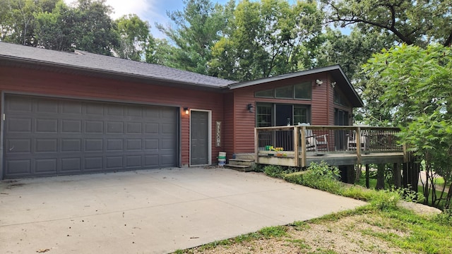 ranch-style house featuring a deck and a garage