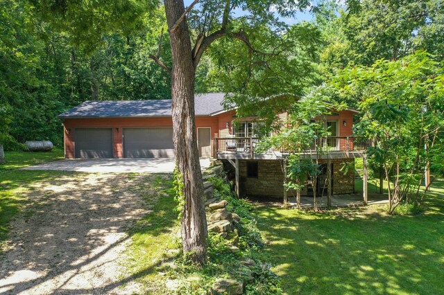 view of front facade with a wooden deck and a front yard