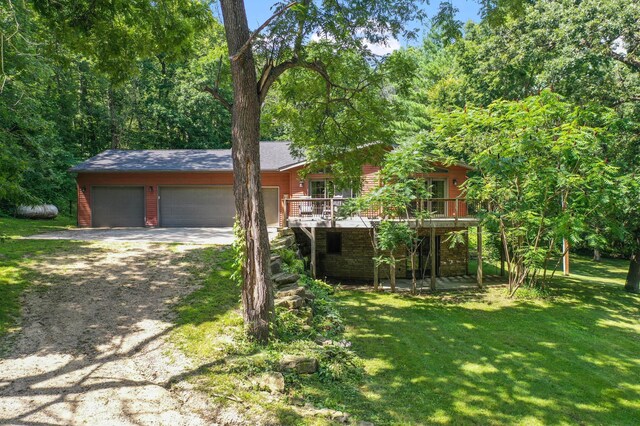 view of front of property featuring a garage and a front lawn