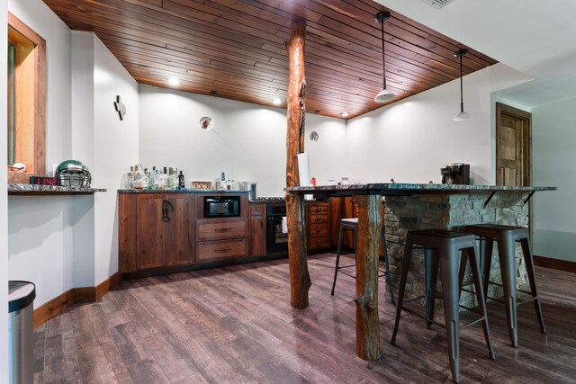 bar featuring dark wood-type flooring, wooden ceiling, black microwave, and hanging light fixtures