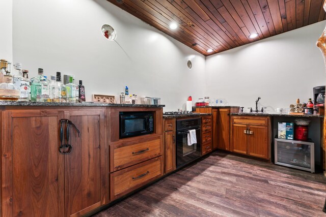 bar featuring wood ceiling, black appliances, dark hardwood / wood-style flooring, and dark stone counters