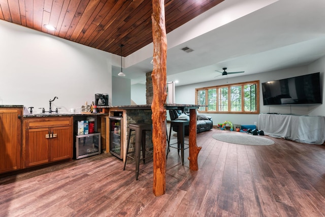 bar with wood ceiling, ceiling fan, hardwood / wood-style flooring, pendant lighting, and sink