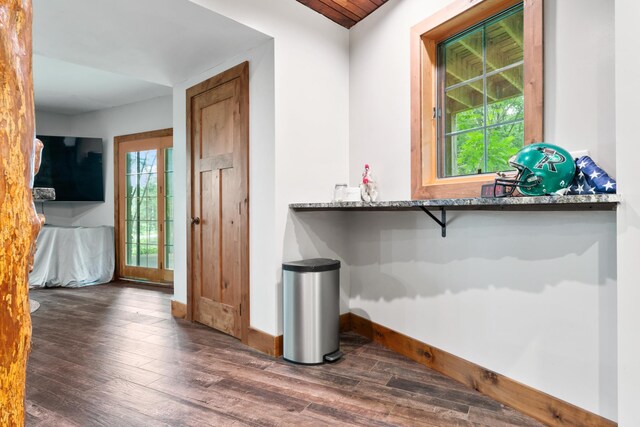 bar with stone countertops and dark hardwood / wood-style floors