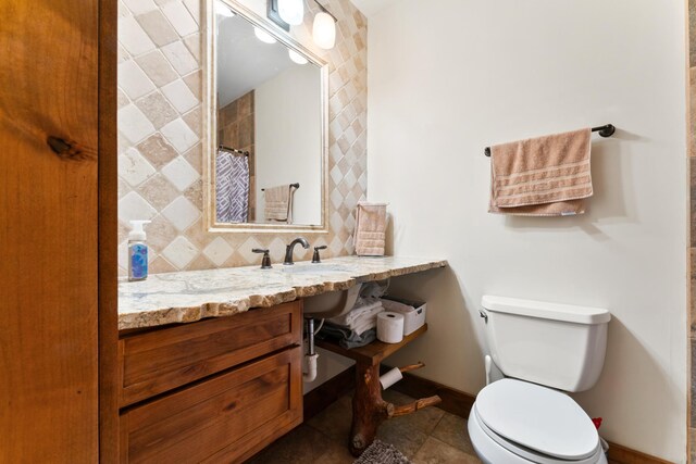 bathroom featuring vanity, toilet, tile patterned floors, and a shower with curtain