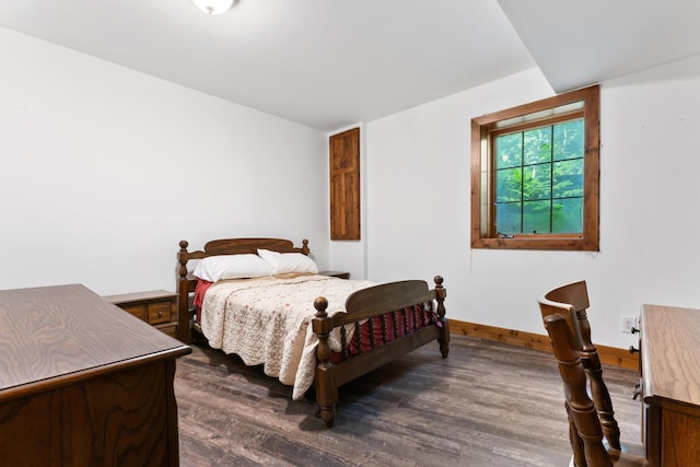 bedroom featuring dark wood-style flooring and baseboards