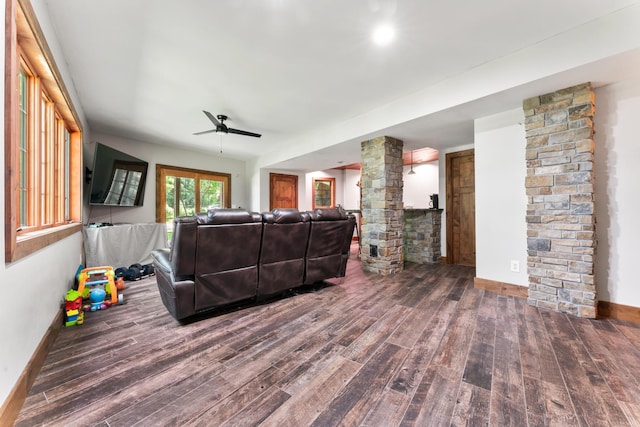 living room with ceiling fan, decorative columns, baseboards, and wood finished floors