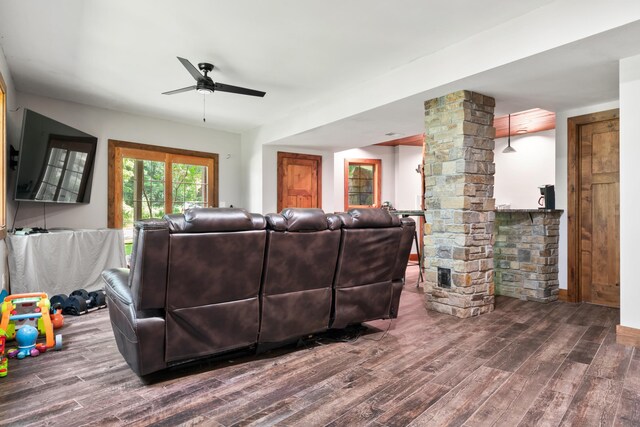 living room with ceiling fan, hardwood / wood-style flooring, and decorative columns