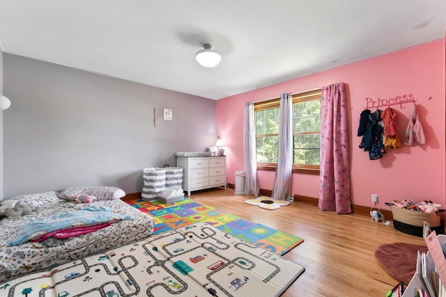 bedroom featuring light wood-type flooring and baseboards