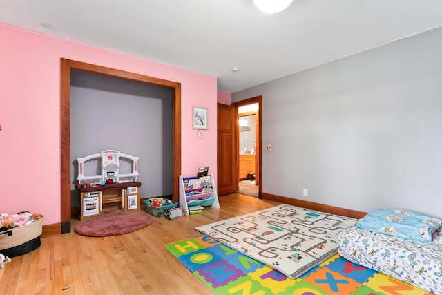 bedroom featuring baseboards and wood finished floors