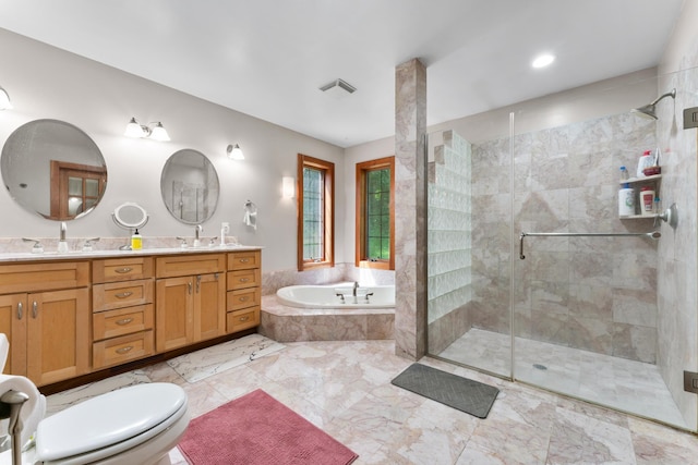 bathroom featuring double vanity, visible vents, a garden tub, a shower stall, and a sink