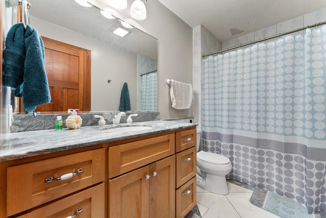 bathroom with curtained shower, toilet, vanity, a textured ceiling, and tile patterned flooring