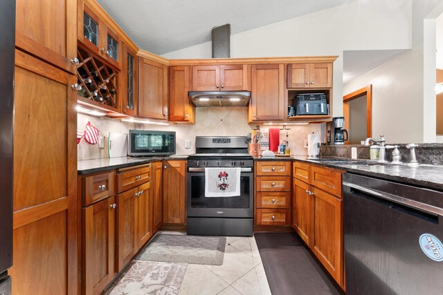 kitchen featuring appliances with stainless steel finishes, sink, backsplash, lofted ceiling, and light tile patterned floors