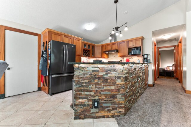 kitchen with light tile patterned floors, high vaulted ceiling, black appliances, and decorative light fixtures