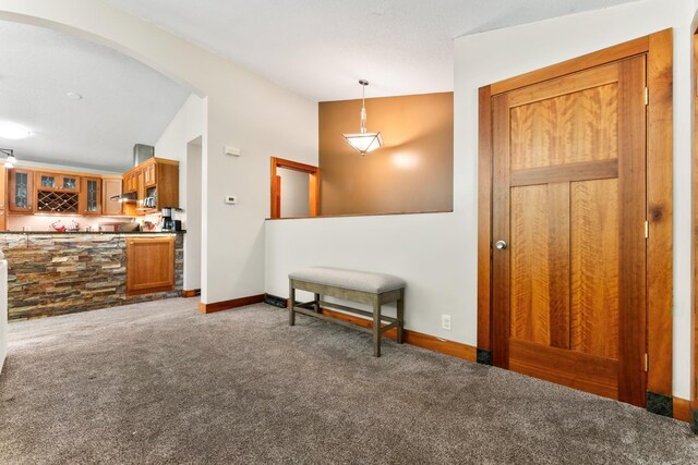 carpeted foyer entrance with lofted ceiling