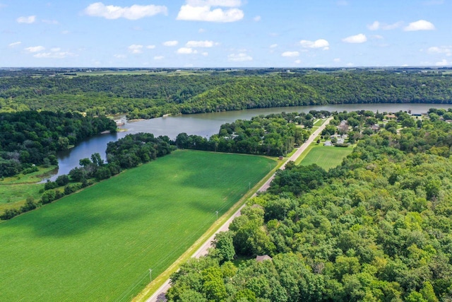 birds eye view of property featuring a water view and a wooded view