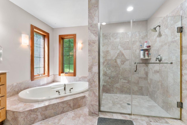 bathroom with vanity, a shower stall, and a bath