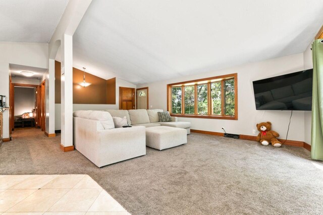 living room featuring lofted ceiling and carpet floors