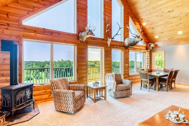 living room with carpet, wood ceiling, high vaulted ceiling, log walls, and a wood stove