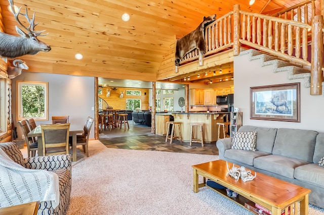 living room with tile patterned floors, a wealth of natural light, and wooden ceiling