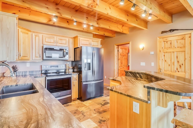 kitchen with appliances with stainless steel finishes, light tile patterned flooring, beam ceiling, and wooden ceiling