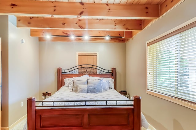 bedroom with beam ceiling and wood ceiling