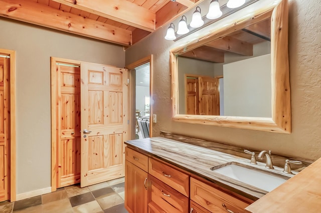 bathroom featuring beamed ceiling, tile patterned flooring, vanity, and wooden ceiling