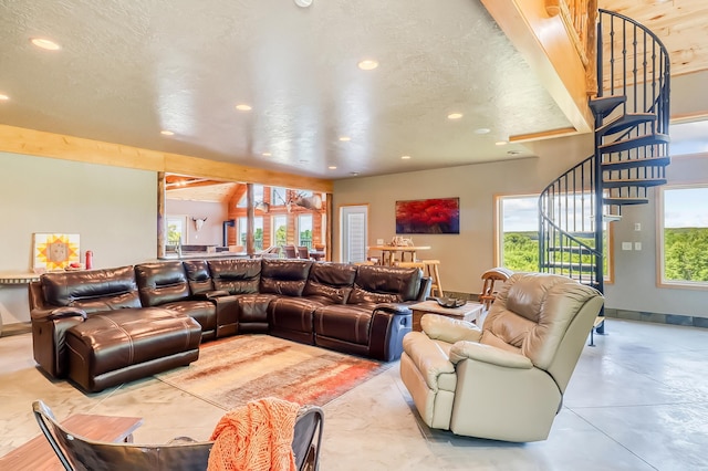 living room with a textured ceiling and a healthy amount of sunlight