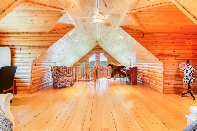 additional living space with hardwood / wood-style flooring, log walls, vaulted ceiling, and wooden ceiling