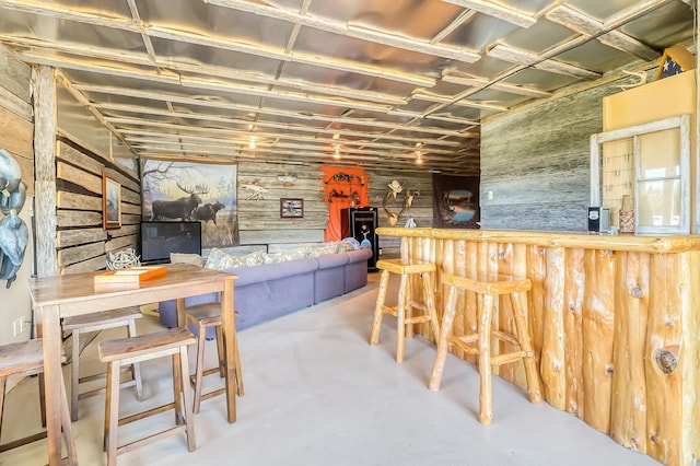 bar with wooden walls and concrete flooring