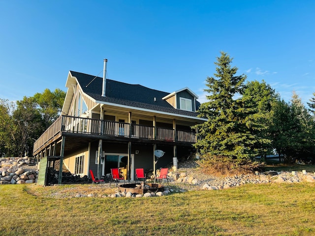 rear view of house featuring a patio and a yard